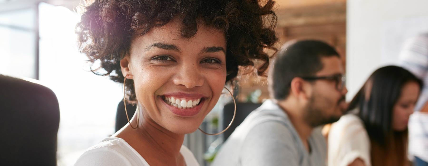 a woman smiling into a camera